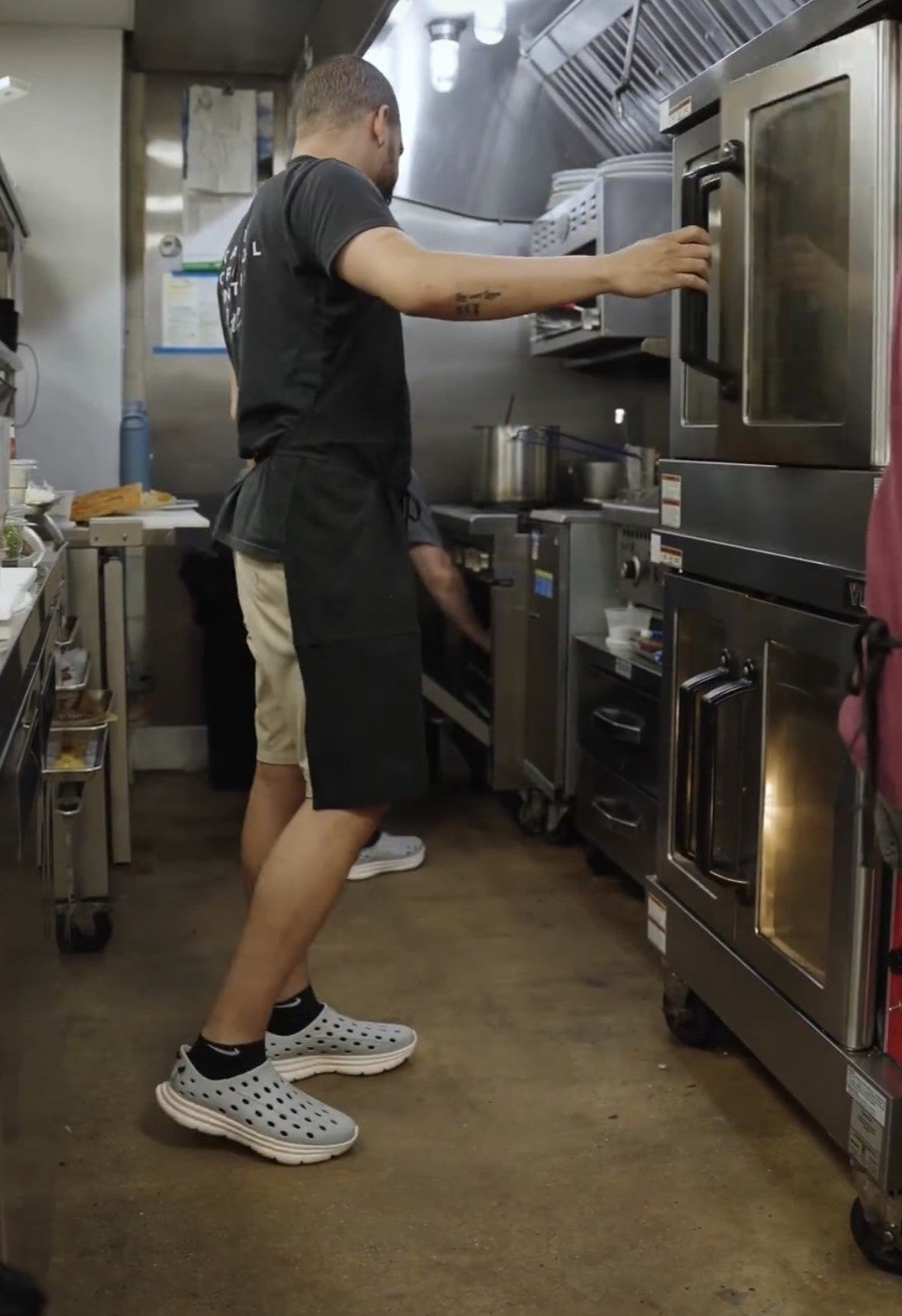 A cook working in the kitchen, wearing his comfortable and non-slip Kane Revive shoes.