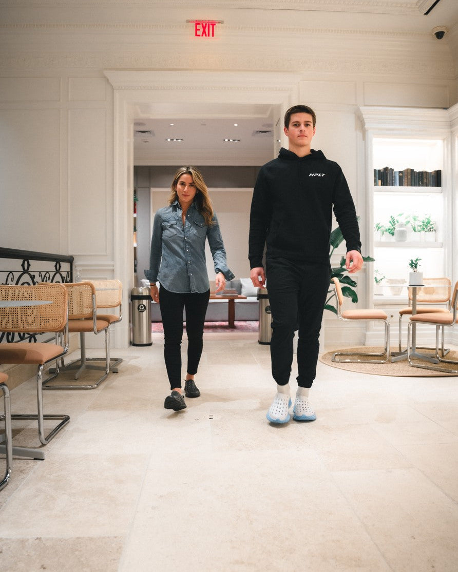Two busy waiters at a restaurant wearing Kane recovery shoes.
