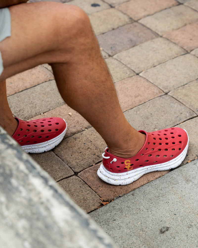 Closeup of a man wearing Red USC Kane Revive Recovery Shoes