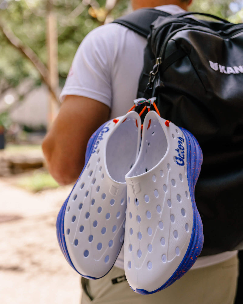 Florida Gators Kane Revive Active Recovery Shoes clipped to a backpack