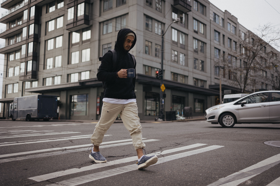 A cashier walking to work in his comfortable Kane Revive recovery shoes.