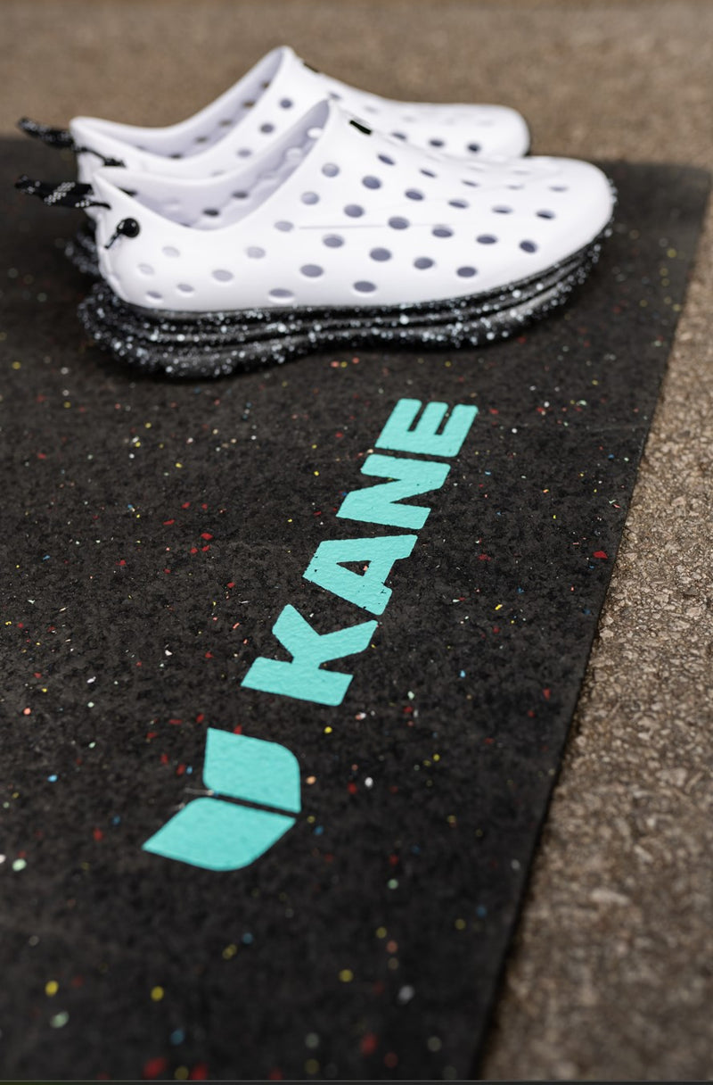 Closeup of White Kane Revive shoes on top of a Kane Renew changing mat