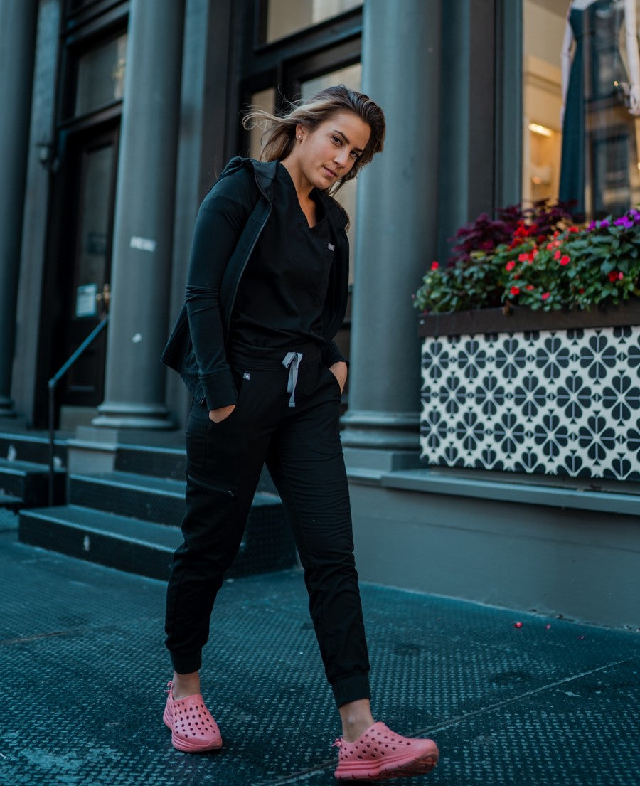 A medical assistant walking to work wearing her stylish Pink Bubblegum recovery shoes.