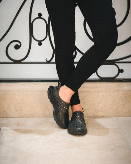 Leg and shoe shot of a waitress wearing Kane Revives and leaning against the wall. Perfect for busy on-your-feet-all-day jobs in the food service industry.